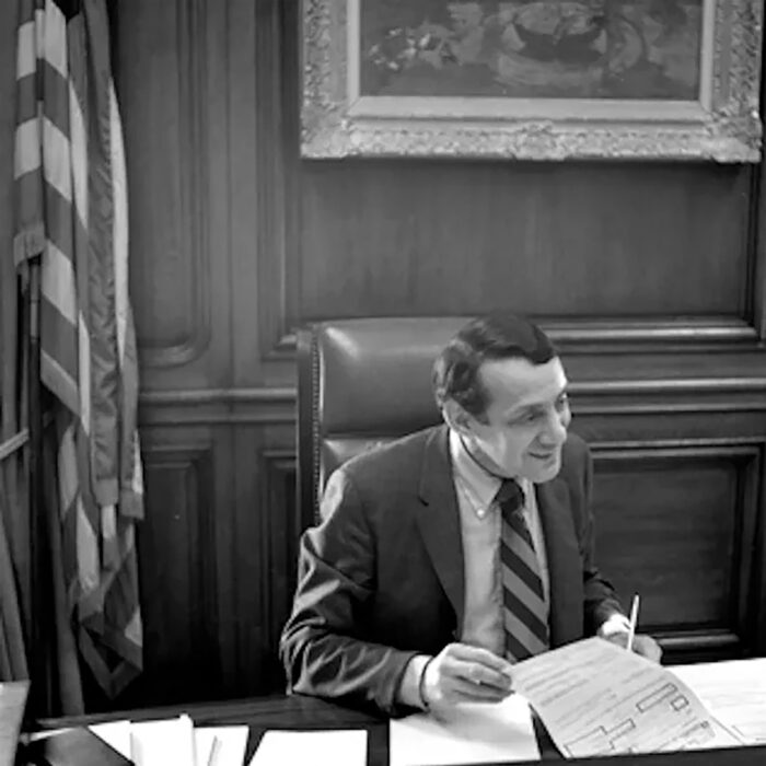 Harvey Milk sits at Mayor George Moscone's dek in 1978